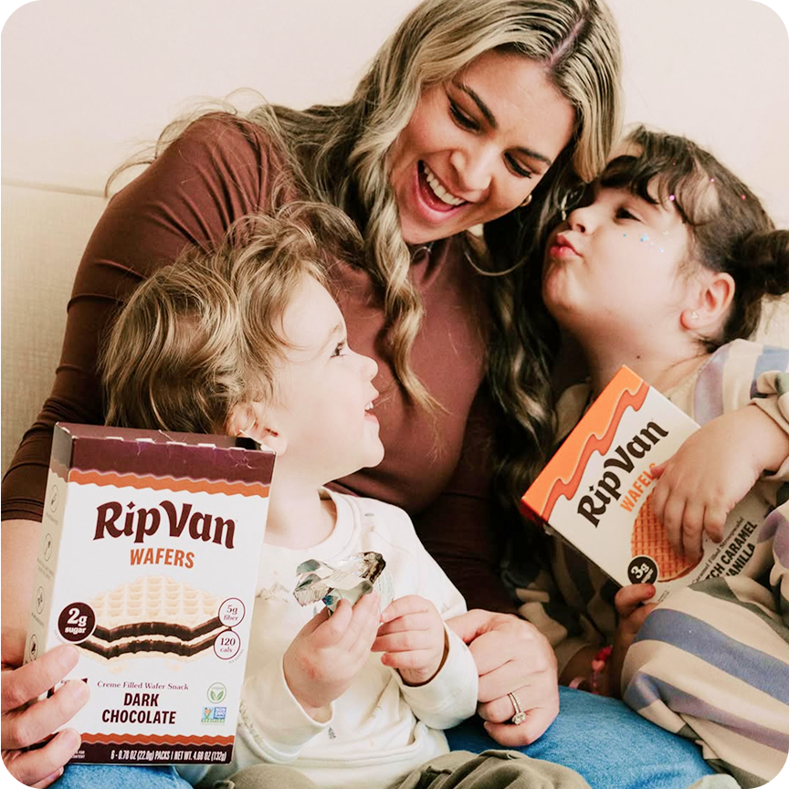 Mother and two children holding Rip Van Wafels boxes Dark Chocolate and Dutch Caramel Vanilla